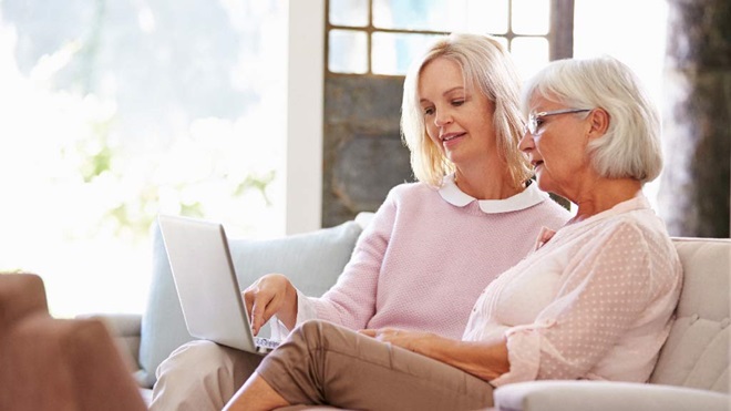 elderly mother and daughter using laptop